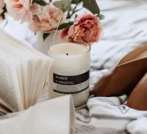 candle and book and a bed
